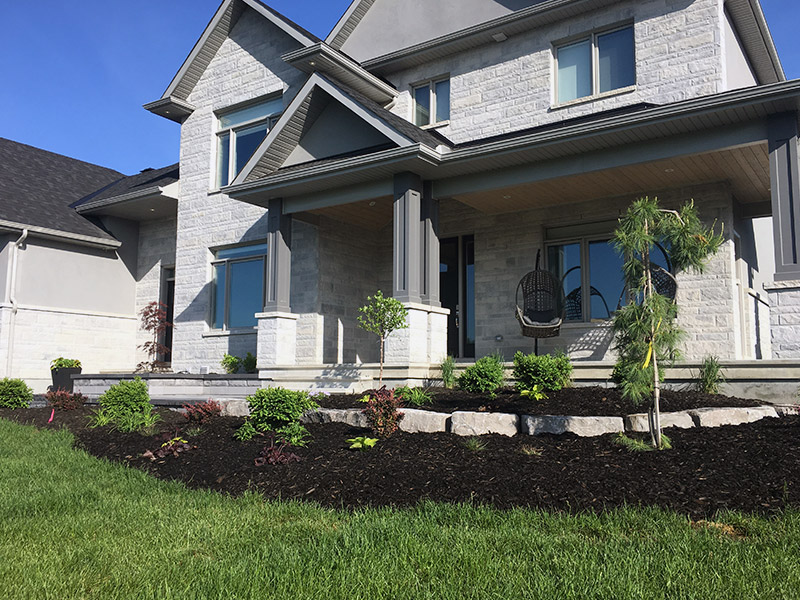 front lawn garden with stone porch